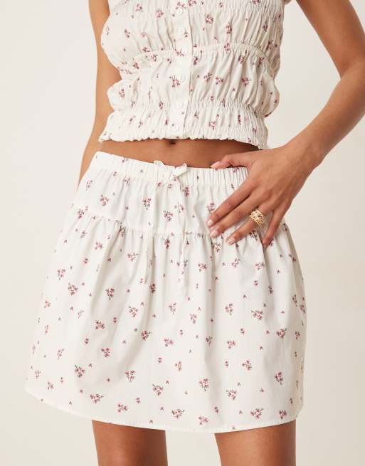 Esmee Exclusive tie front mini beach skirt with trim detail in white and pink ditsy print, 2 of 5