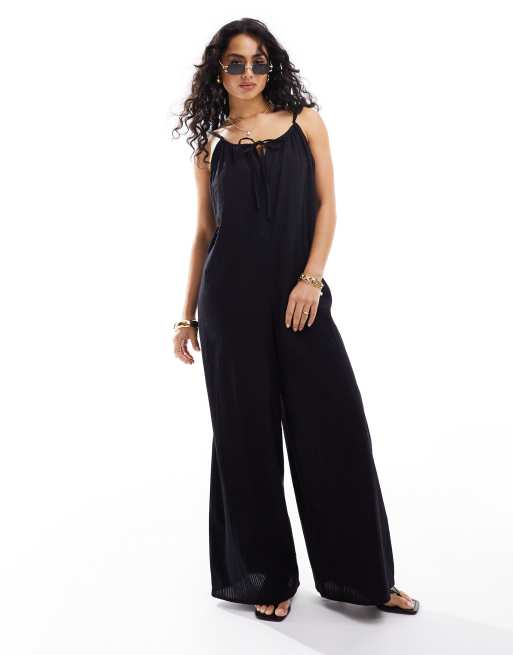 Esmée - Tuta jumpsuit ampia da mare nera trasparente scollata sul retro con allacciatura frontale