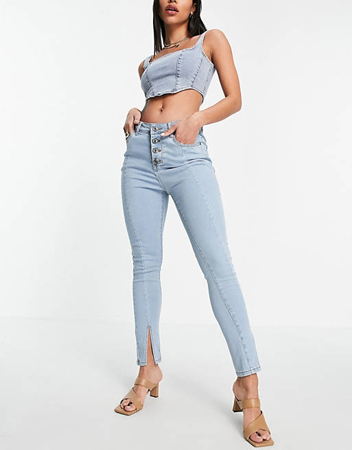 Fae skinny jeans with split front and exposed buttons in light wash denim