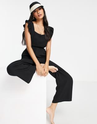 Fashion Union Exclusive frill beach jumpsuit in black - ASOS Price Checker