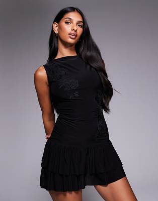 Fashionkilla Fashionkilla exclusive double sculpted slinky slash neck low back ruffle hem flower applique mini dress in black