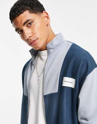 Джемперы и кардиганы Флисовая oversized-куртка синего цвета со вставками и воротником-стойкой ASOS Unrvlld Spply-Темно-синий