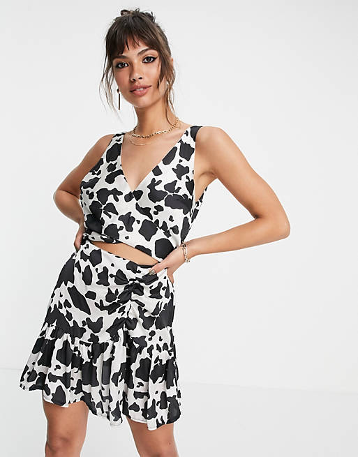 Flounce London ruched mini dress with cut out in cow print