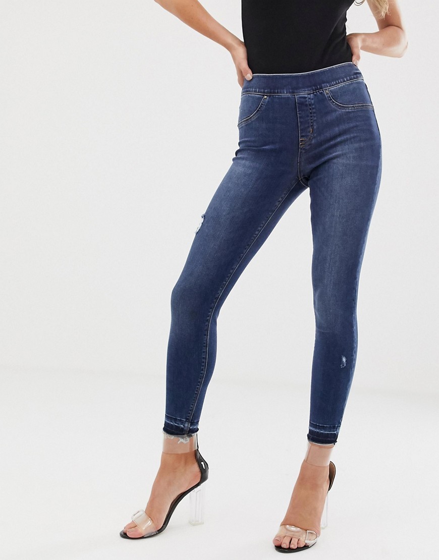 Form-og-løft skinny jeans med slidte detaljer fra Spanx-Blå
