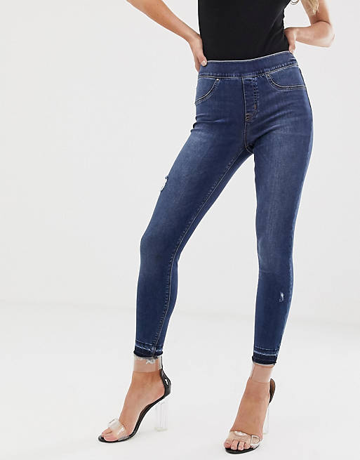 Form-og-løft skinny jeans med slidte detaljer fra Spanx