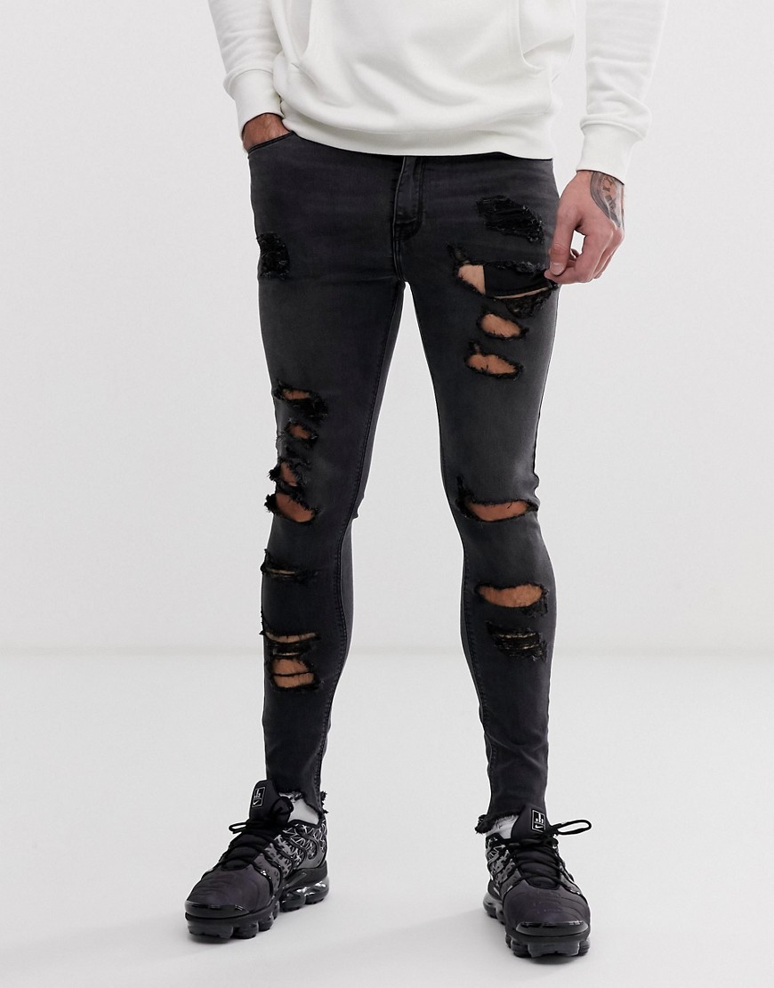 Forvaskede, sorte spray-on-jeans i powerstretch med rå søm og kraftige flænser fra ASOS DESIGN