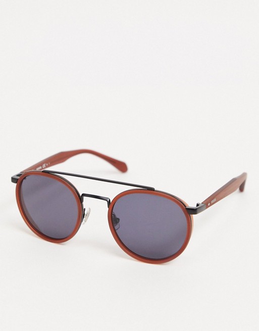 Fossil round sunglasses with wire frame detail in brick red