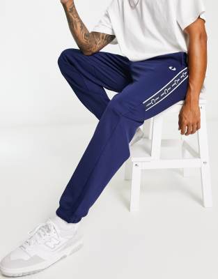 Fred Perry taped trackies in navy - ASOS Price Checker