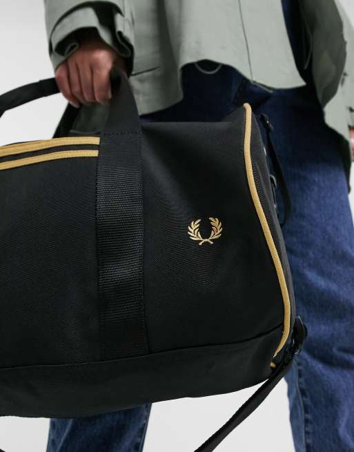 Fred Perry twin tipped barrel bag in black and gold