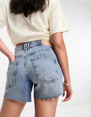 Free People classic denim raw edge shorts in mid blue - ASOS Price Checker