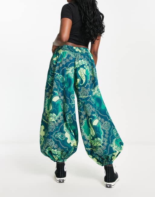 Free People paisley print velvet low rise flares in emerald green, ASOS