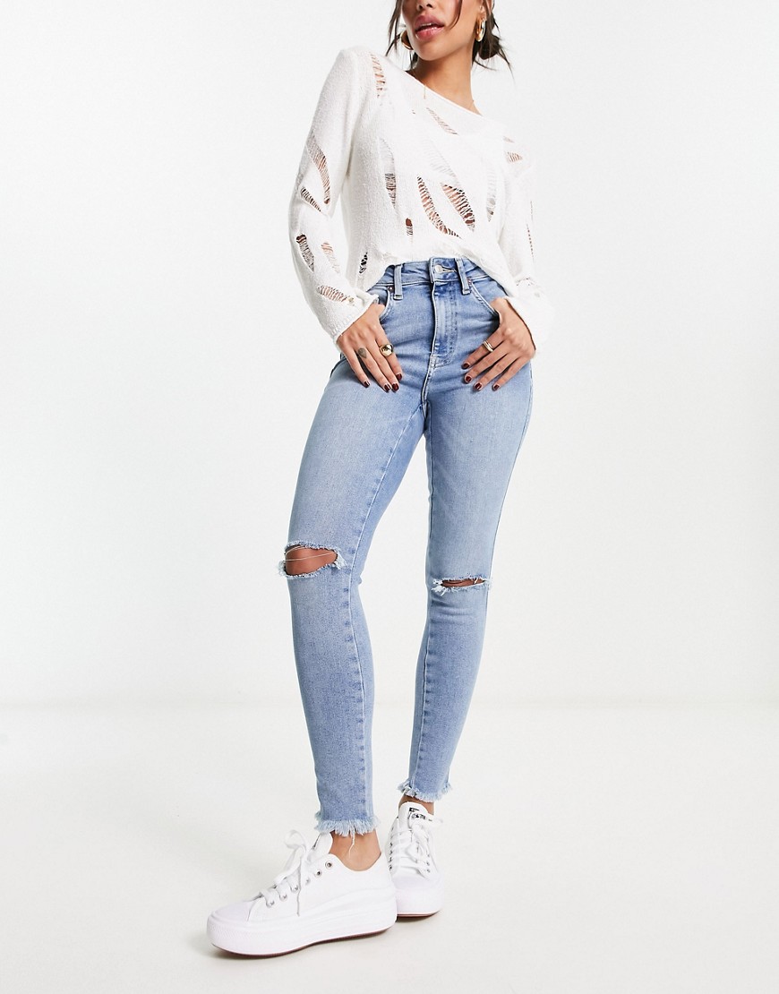 Free People skinny jeans with rip details in light blue