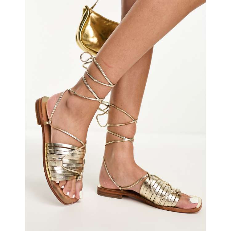Free People strap detail flat sandals in gold ASOS