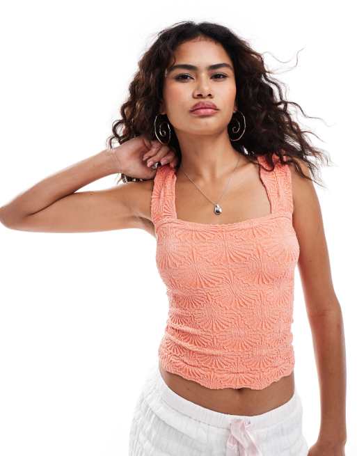 Free People textured stretch camisole top in coral orange