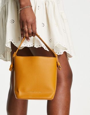 French Connection minimal bucket bag in mustard