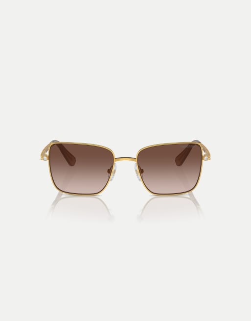 Gafas de sol amarillo dorado con montura redondeada y lentes marrones de Swarovski