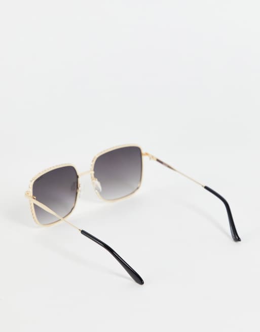 Gafas de sol con montura dorada y lentes degradados rectangulares