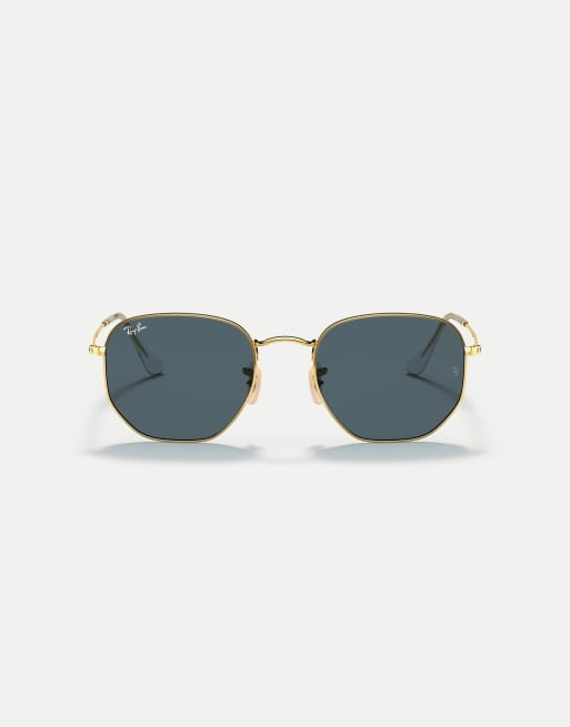 Gafas de sol doradas con montura hexagonal irregular y lentes azules planas de Ray-Ban