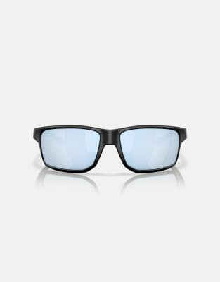 Gafas de sol negro mate con montura rectangular extragrande y lentes azules polarizadas efecto espejo Gibston de Oakley - view 1