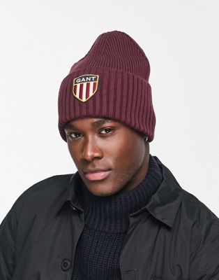 GANT wool beanie in burgundy red with large shield logo - ASOS Price Checker
