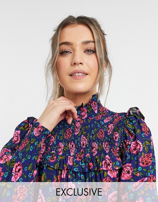 Ghost Fia blouse with high neck and frill detail in red and blue floral print
