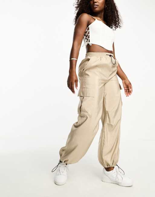 influencer wearing a white corset top with beige cargo pants and sneakers