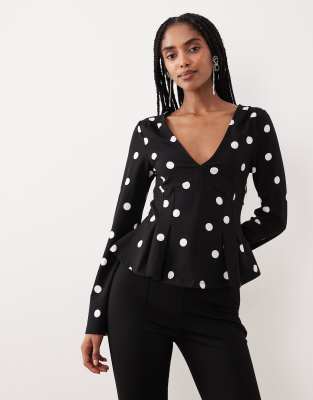 Gina Tricot - Langärmliges Schößchenoberteil in Schwarz mit Polka Dots