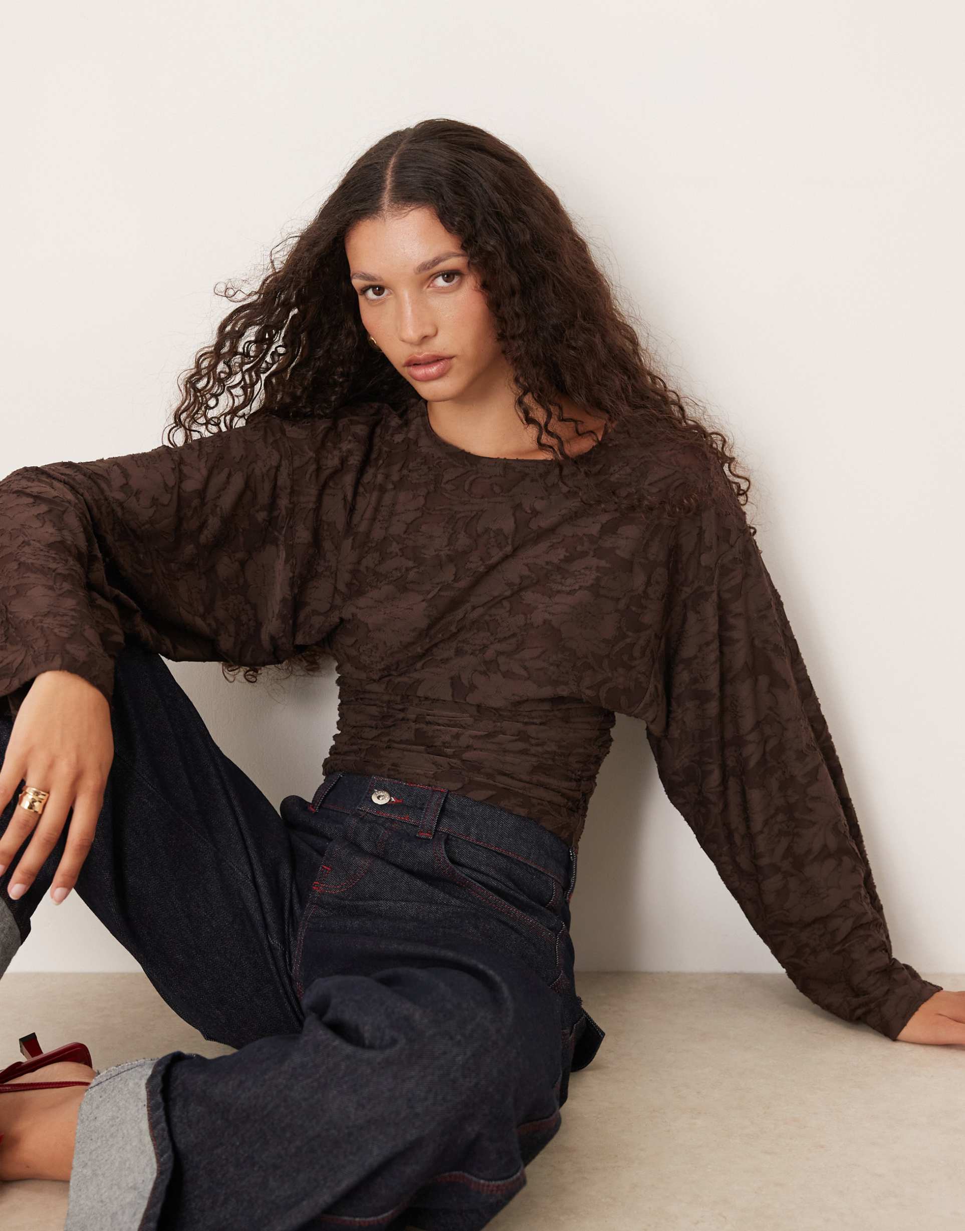 gina tricot long sleeve textured print crew neck top in dark brown