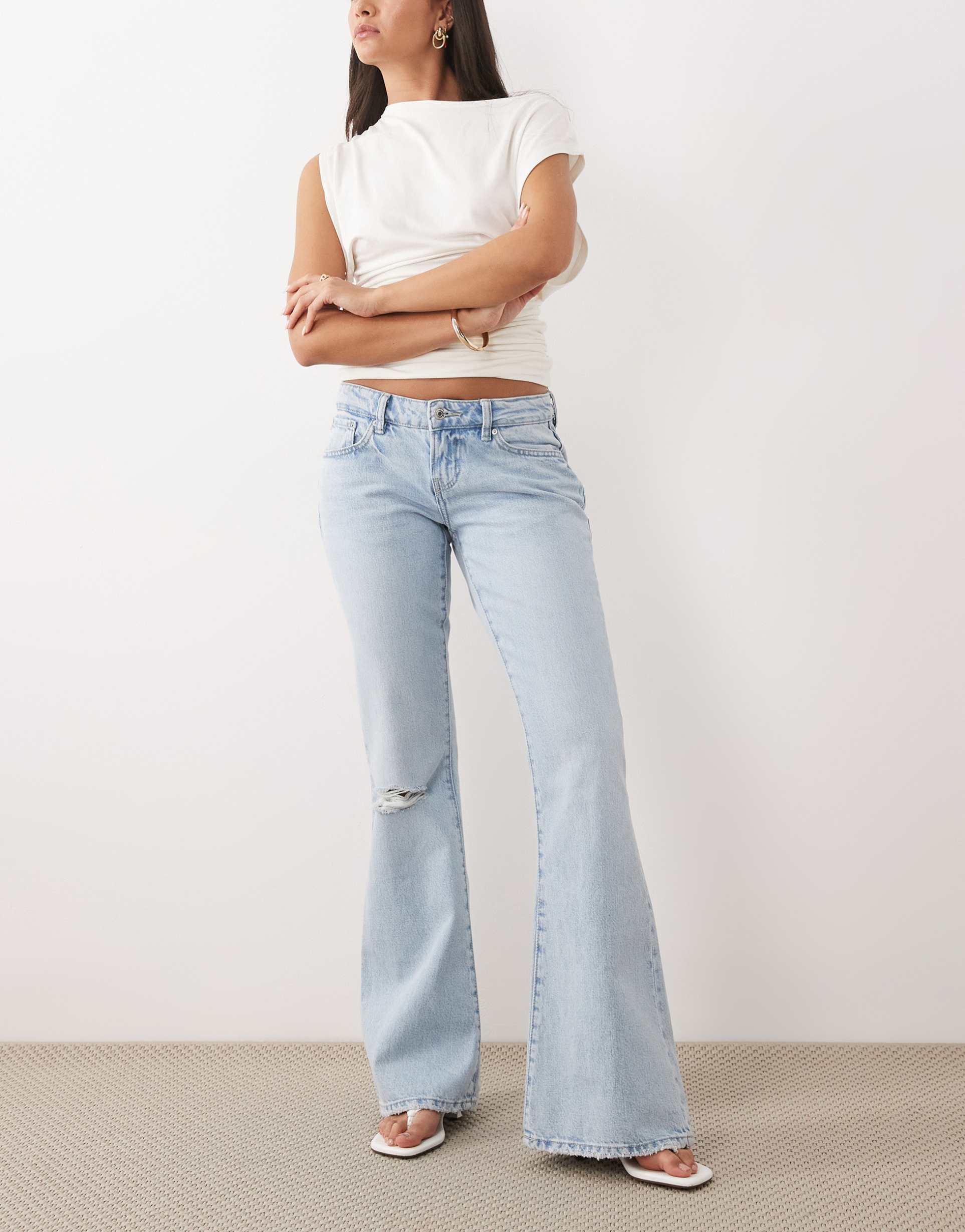 gina tricot low waist flare ripped jeans in lightwash blue
