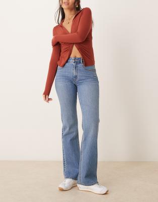 mid rise bootcut stretch jeans in mid wash blue