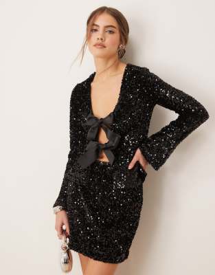 mix and match sequin top with tie-front bow detail and fluted sleeves in black