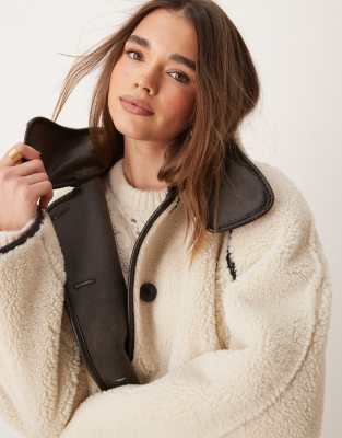 oversized reversible teddy jacket with high funnel neck in off white with contrast edging