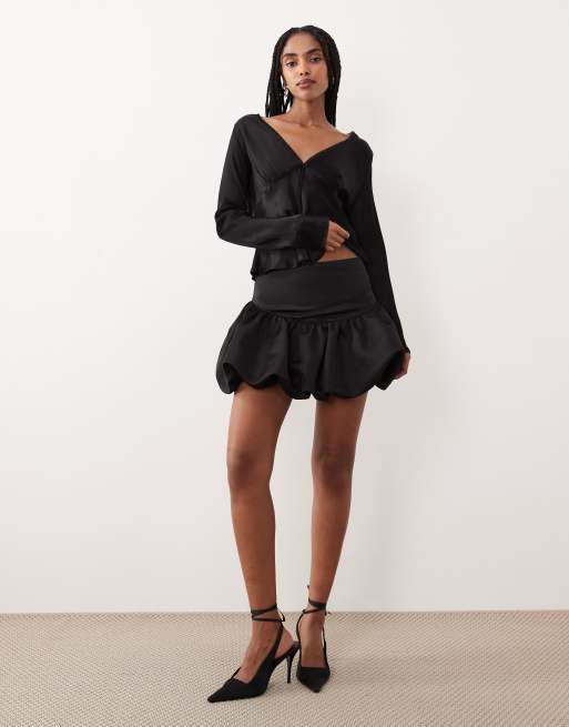 Gina Tricot satin dropped waist balloon mini skirt in black | ASOS