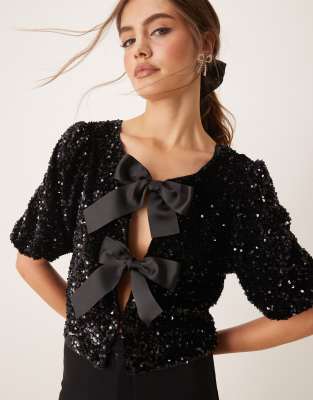 sequin short sleeve top with satin bow front in black