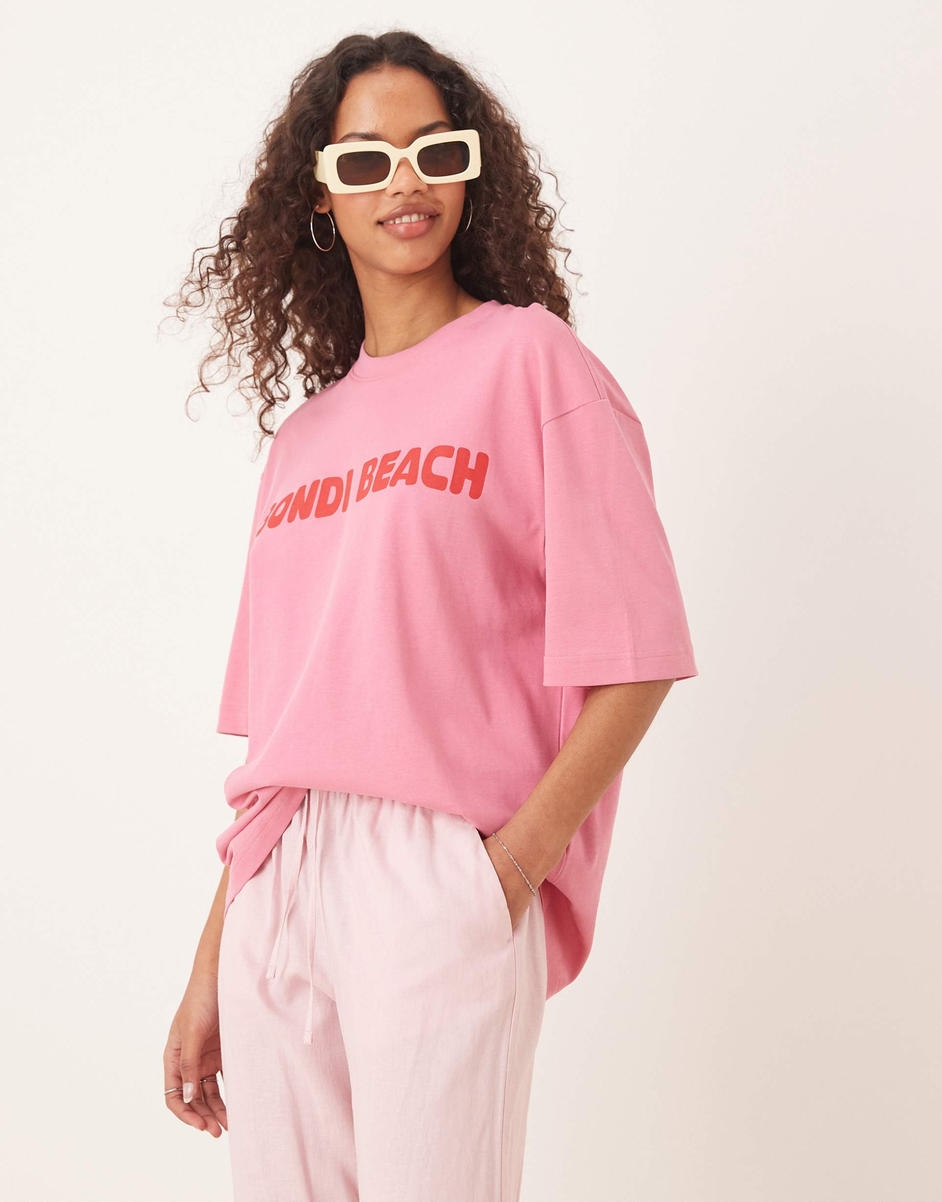 gina tricot short sleeve bondi beach graphic oversized t-shirt in pink