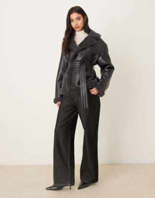 Gina Tricot short teddy PU belted jacket in black with dark gray collar trim