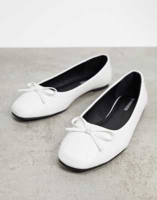 white flat pumps