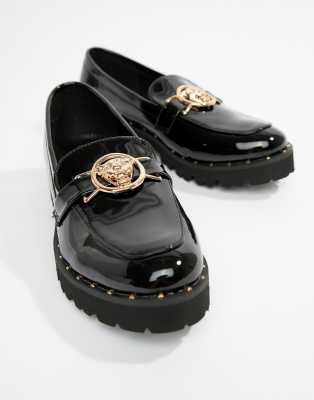 black flat shoes with gold buckle