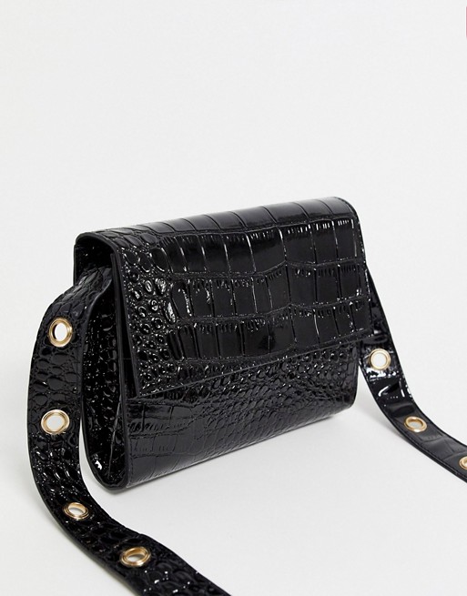Glamorous crossbody bag in black patent with gold eyelet detail strap
