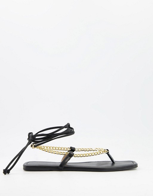 Glamorous flat sandals with chain detail in black
