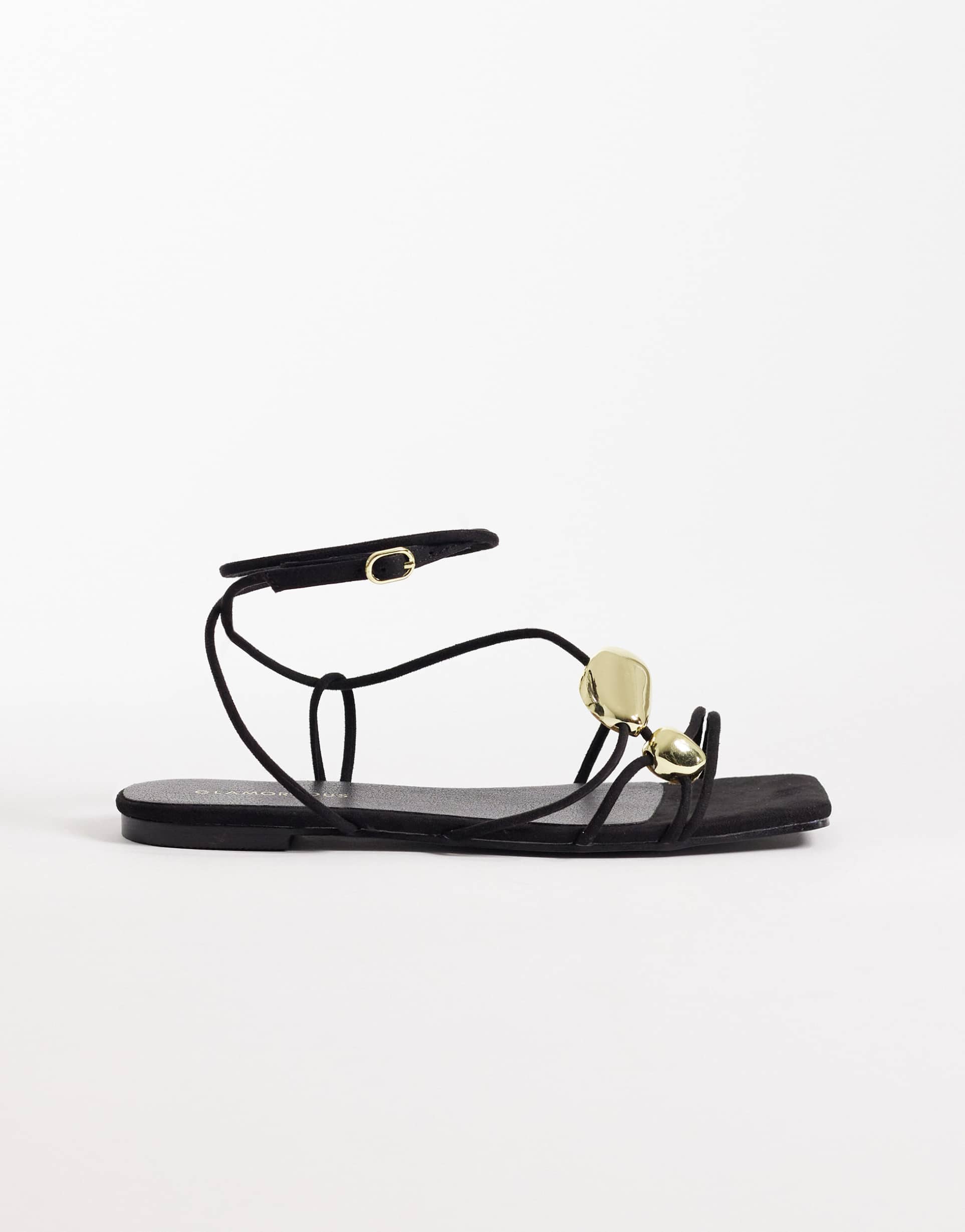 glamorous flat sandals with molten detailing in black and gold tone