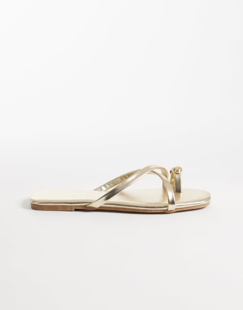 Glamorous flat sandals with toe ring in gold - view 1