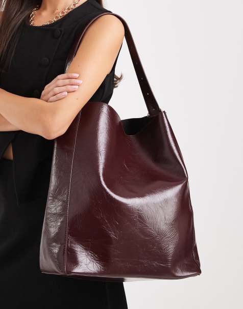Glamorous large slouchy shoulder bag in high shine burgundy - view 1