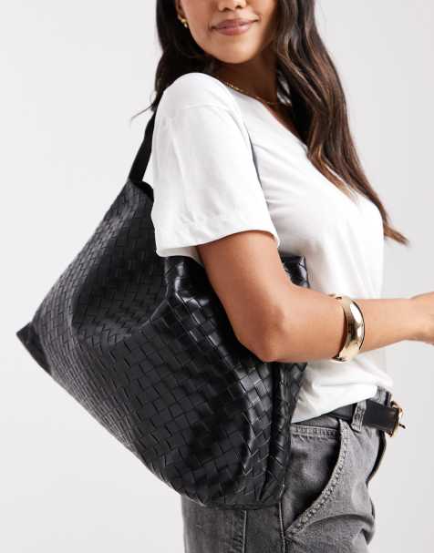 Glamorous oversized woven shoulder bag in black - view 1