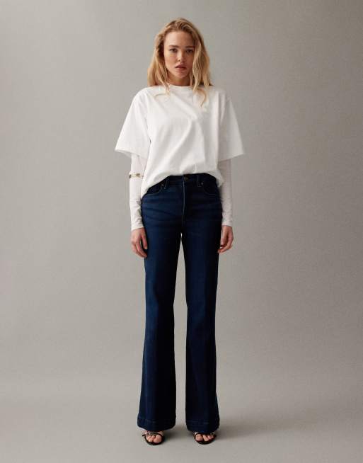Good American - Good Legs - Flared compressiejeans in donkerblauwe wassing, 2 van 7