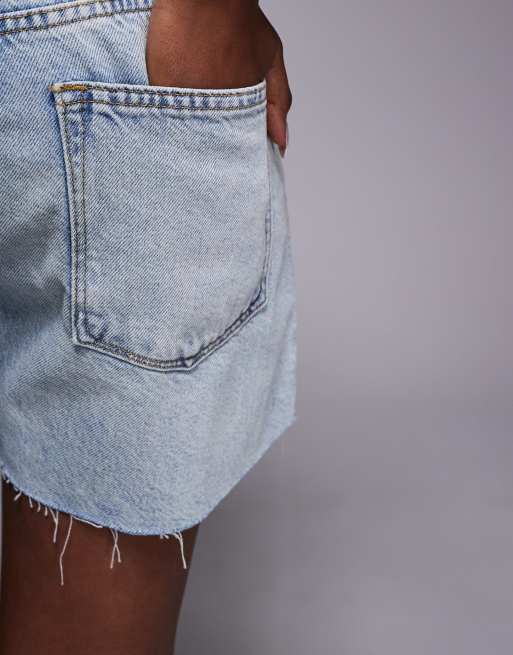 Good American good standard raw hem long denim shorts in mid blue wash, 4 of 5