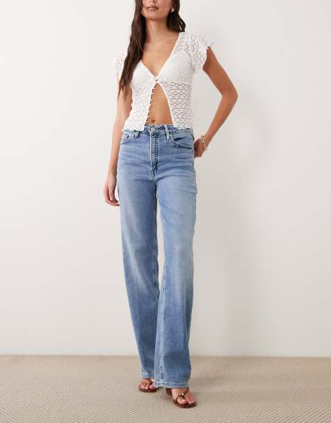 Good American high rise soft tech true straight jeans in light blue wash - view 1