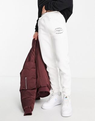 Good For Nothing joggers in off white with crest logo print