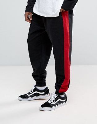 black tracksuit bottoms with red stripe