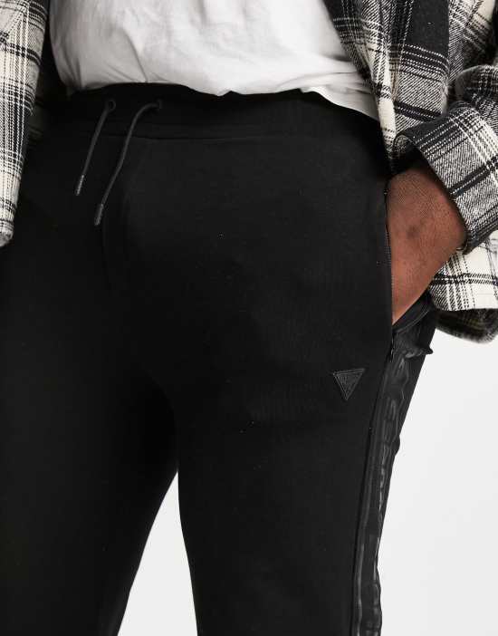 https://images.asos-media.com/products/guess-arlo-sweatpants-with-side-logo-taping-in-black/24420843-4?$n_550w$&wid=550&fit=constrain